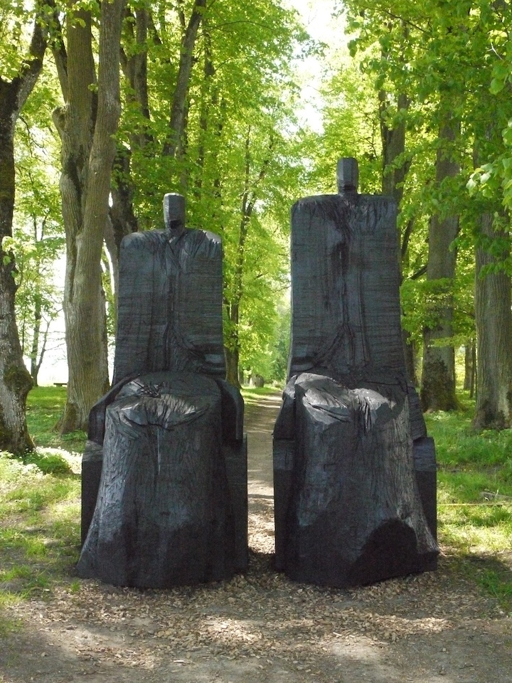 2 bonhommes en bois calcinés. C'est une oeuvre de l'artiste français Christian Lapie, à découvrir sous les arbres centaines du Château de Vullierens.